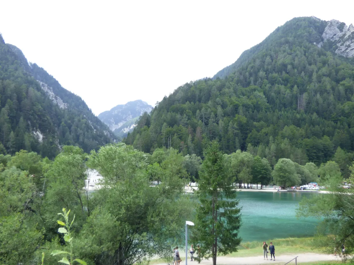 Emerald green lake and its footbridge seen from the heights