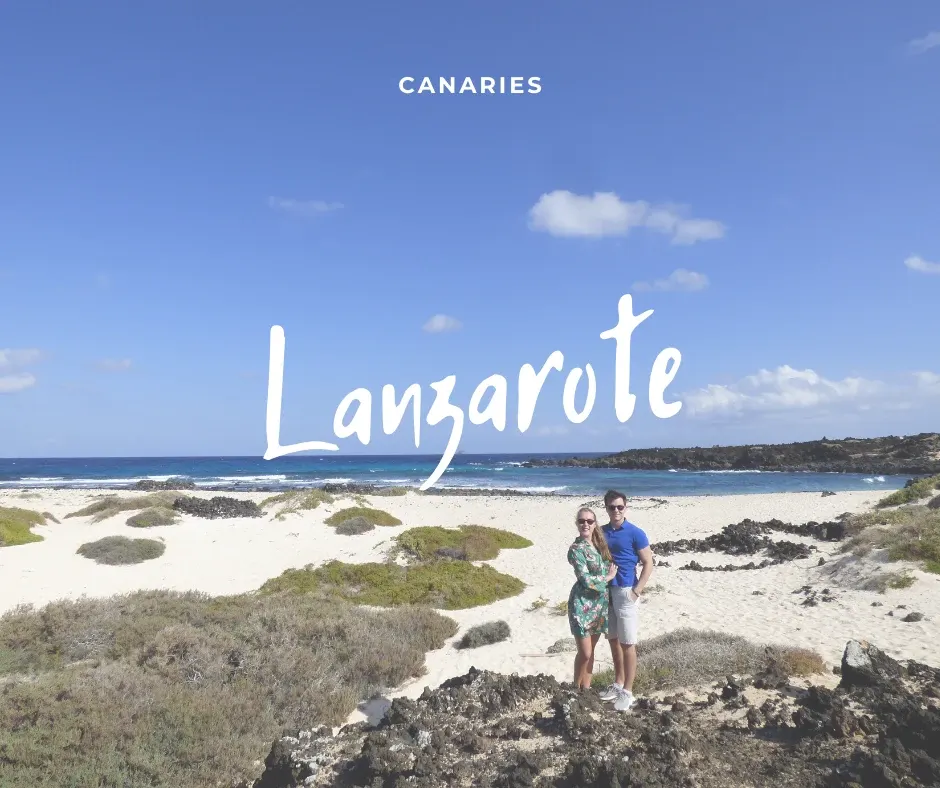 Couple on a beach of white sand and black rock, title Lanzarote