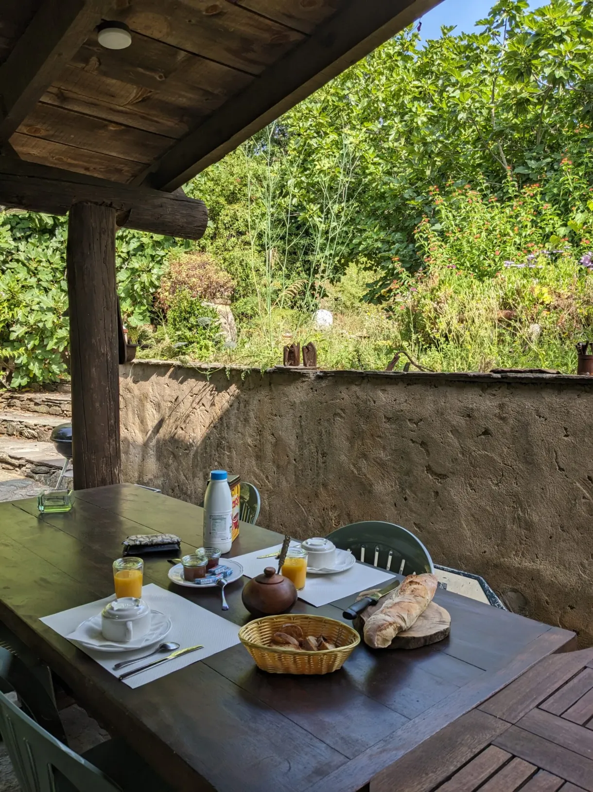 Breakfast laid out beneath a canopy of stone and wood