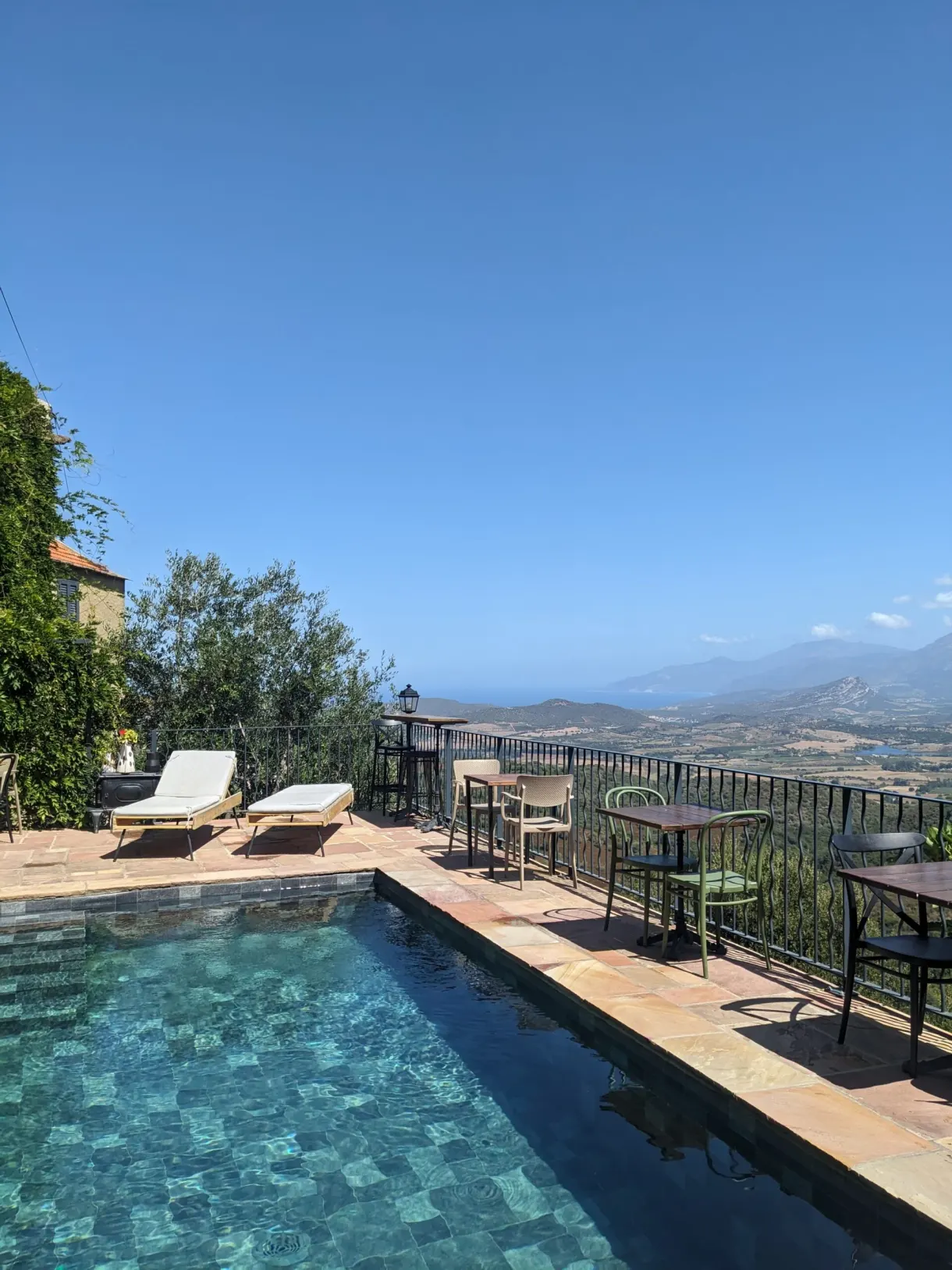 Pool and sun loungers overlooking the plain down to the sea