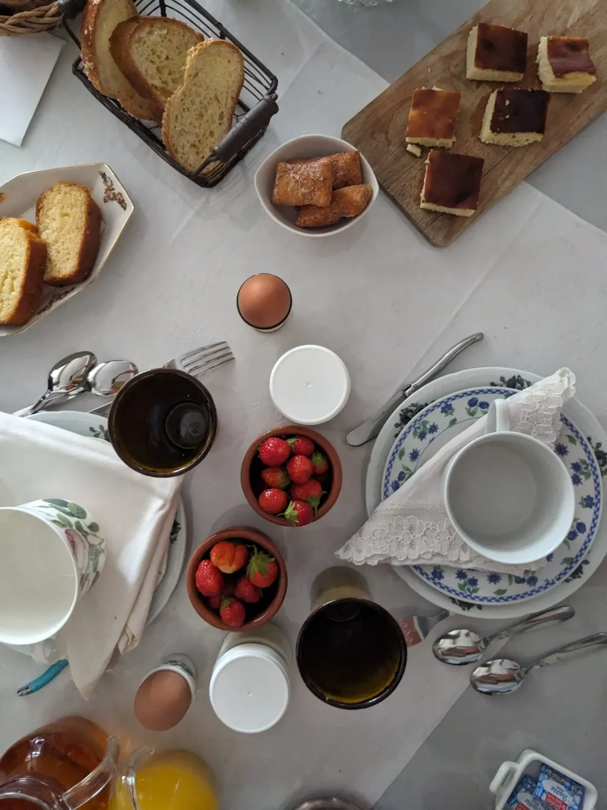 Breakfast table seen from above, strawberries and jams