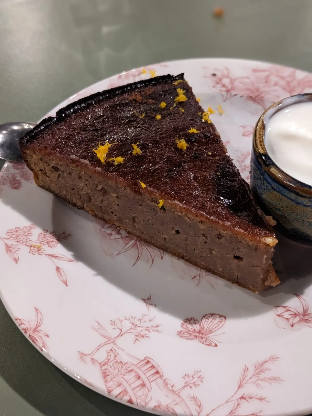 Slice of molten chocolate cake and citrus zest