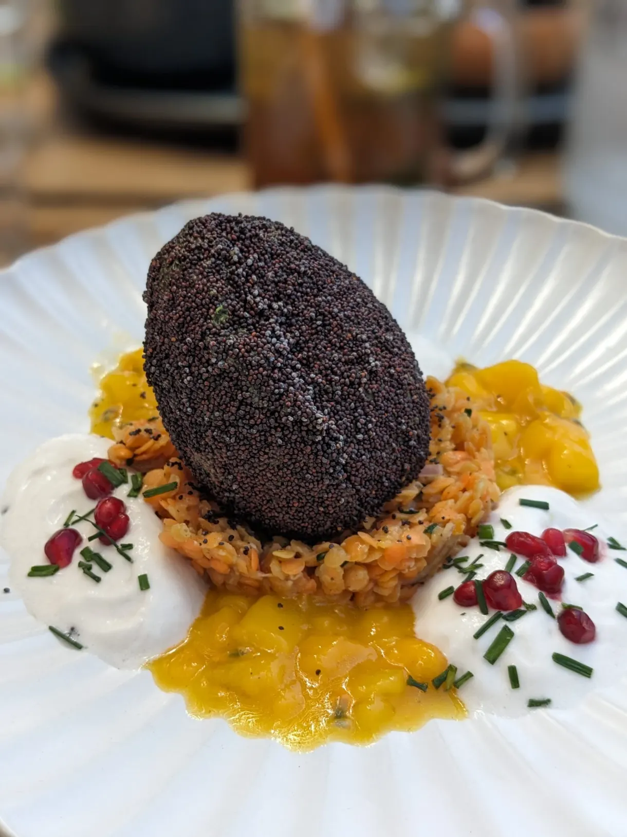 Dark gourmet plate set on a saffron coulis