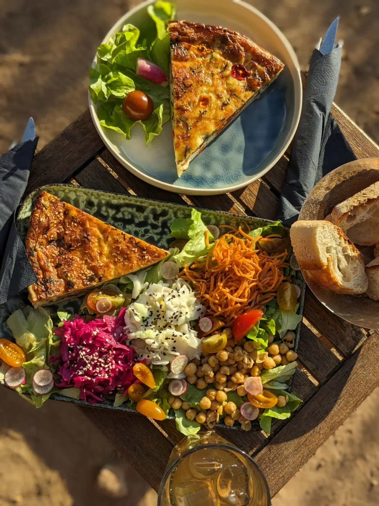 Platter of savoury tarts, raw vegetables and bread to share