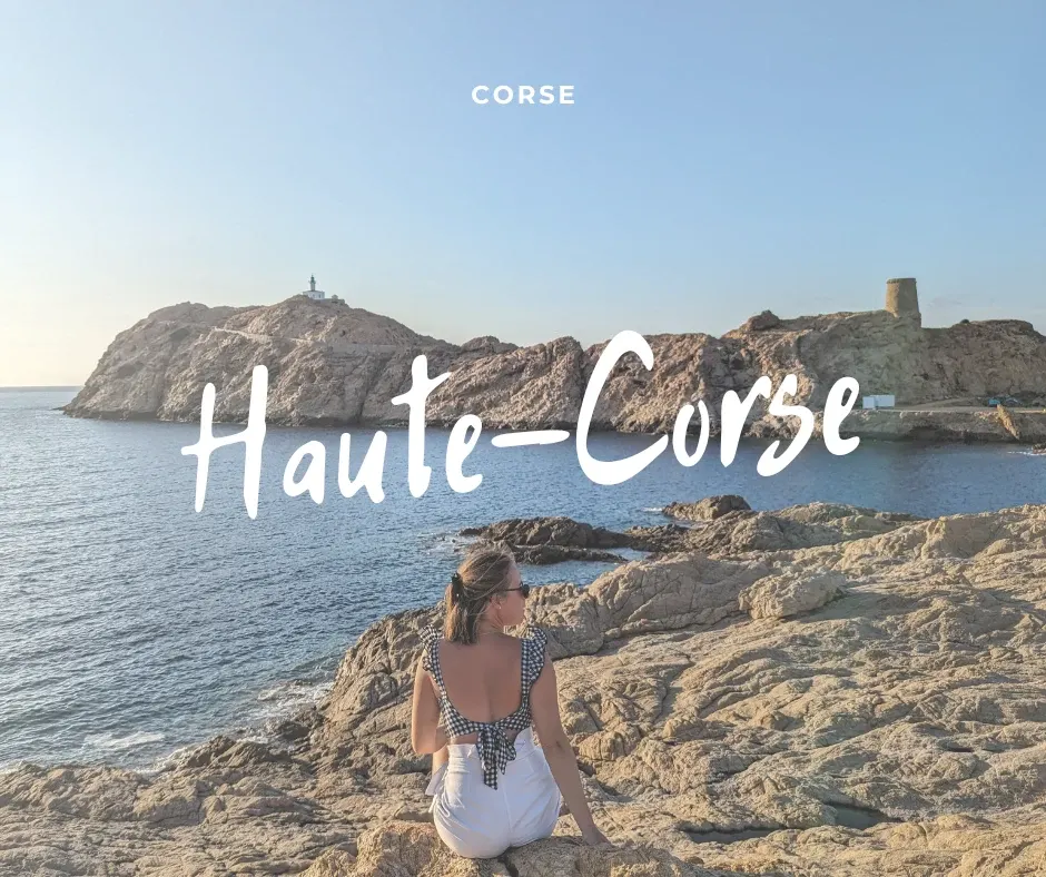 Woman sitting on the rocks facing an islet and its Genoese tower