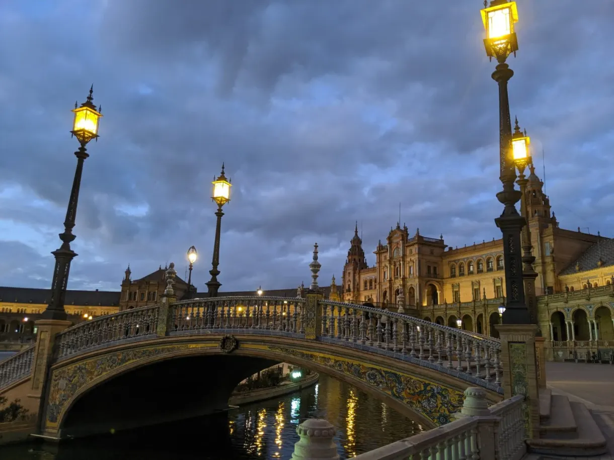 Ceramic bridge and street lamps lit as night falls