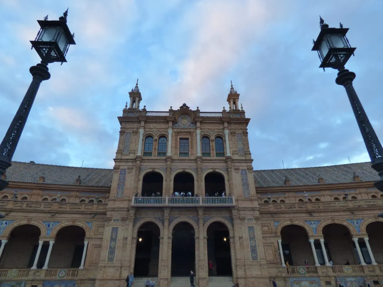 Central body of the palace framed by two tall street lamps