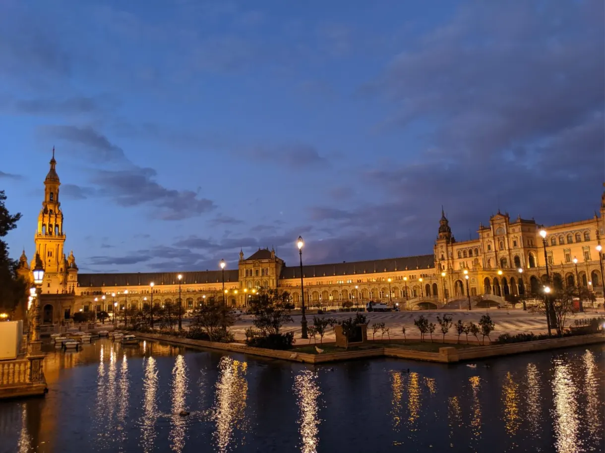 Palace lit up and golden reflections on the canal, midnight blue sky