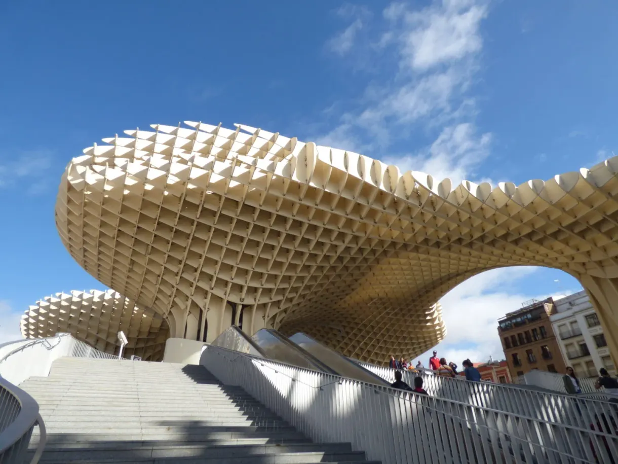 White staircase climbing beneath the pale wooden vaults