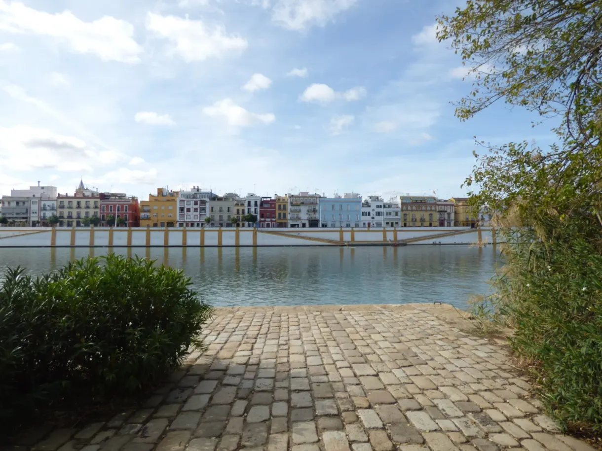 Paved bank facing the colourful houses on the far side