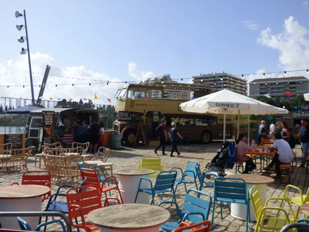 Food truck terrace with colourful chairs on the quay