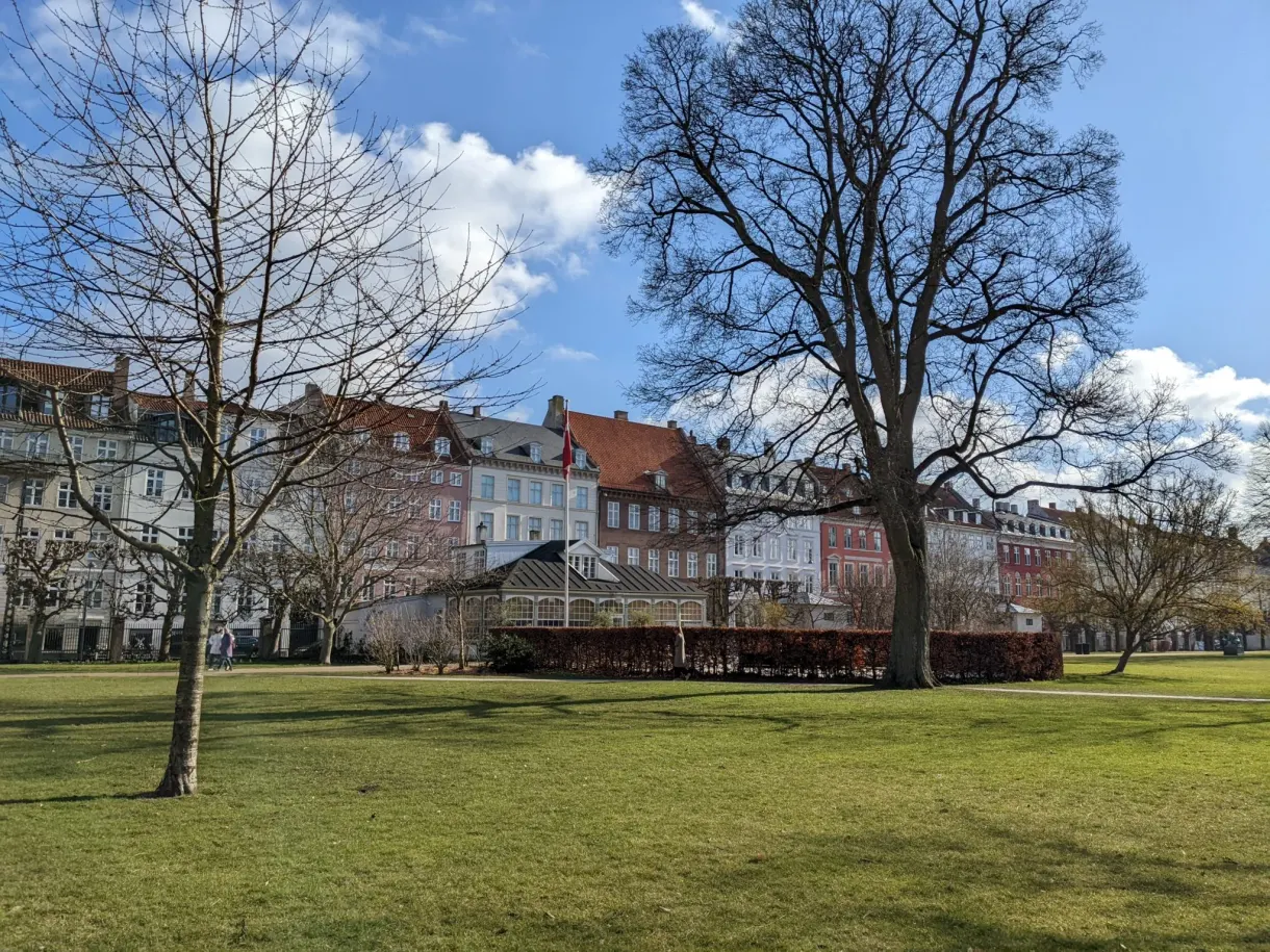 Grande pelouse du jardin royal cernée de façades colorées