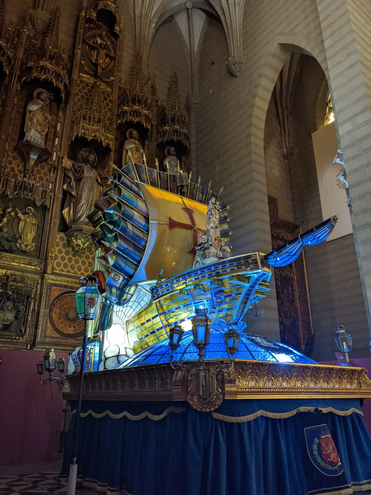 Blue glass processional float lit up in the nave