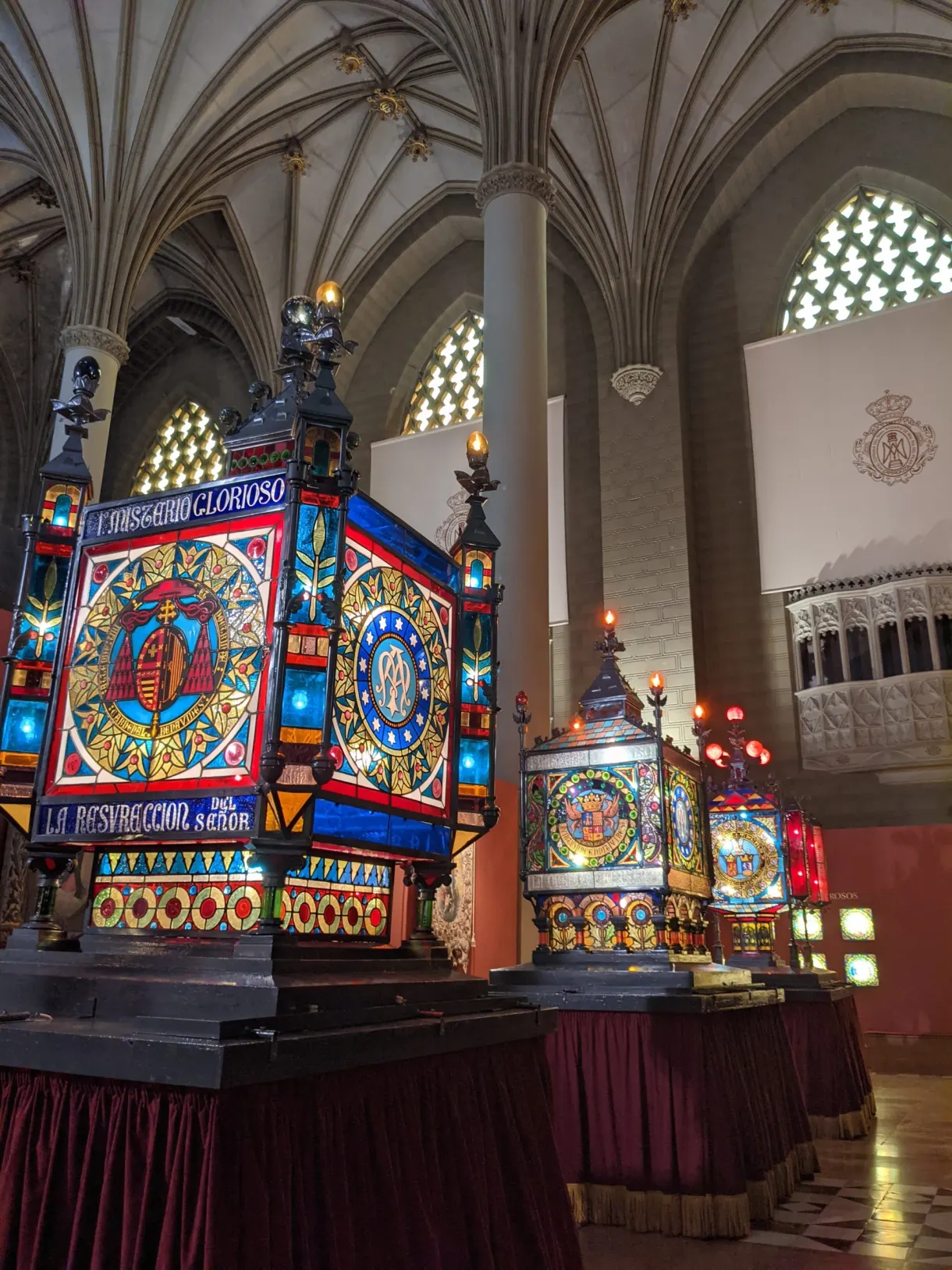 Colourful processional floats beneath the Gothic vaults