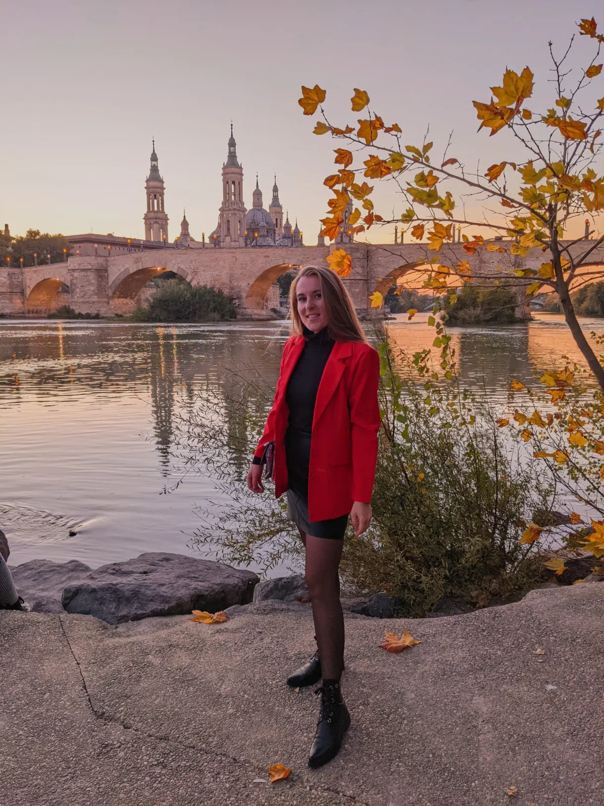 Woman in a red jacket beside the Ebro in autumn