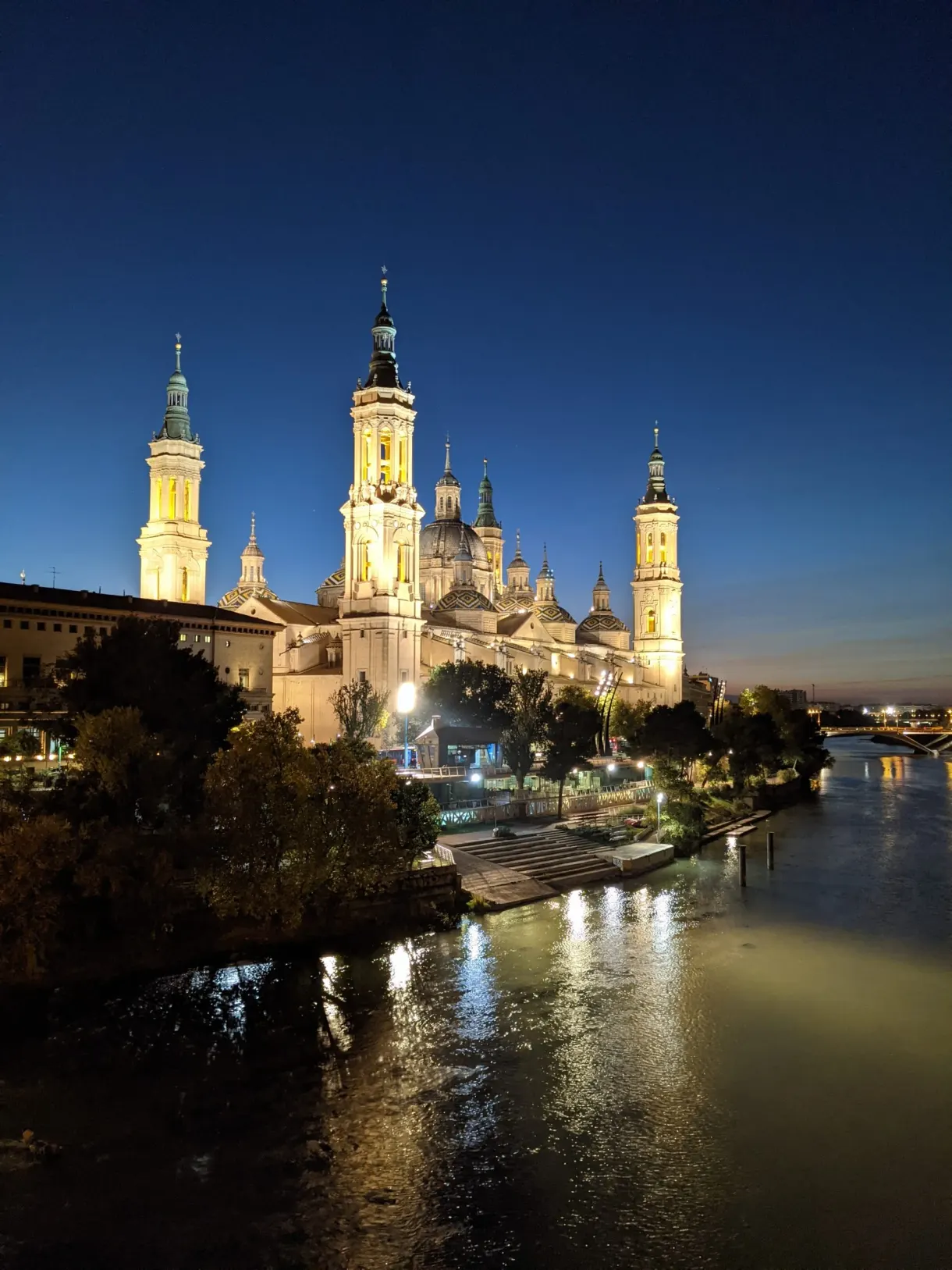 Illuminated basilica reflected in the river at night