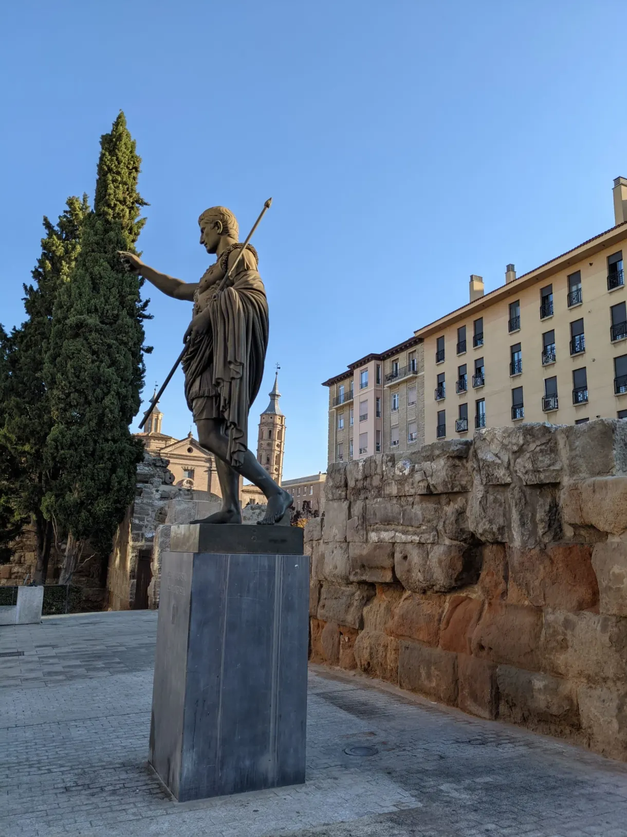 Bronze statue of Augustus in front of the Roman walls