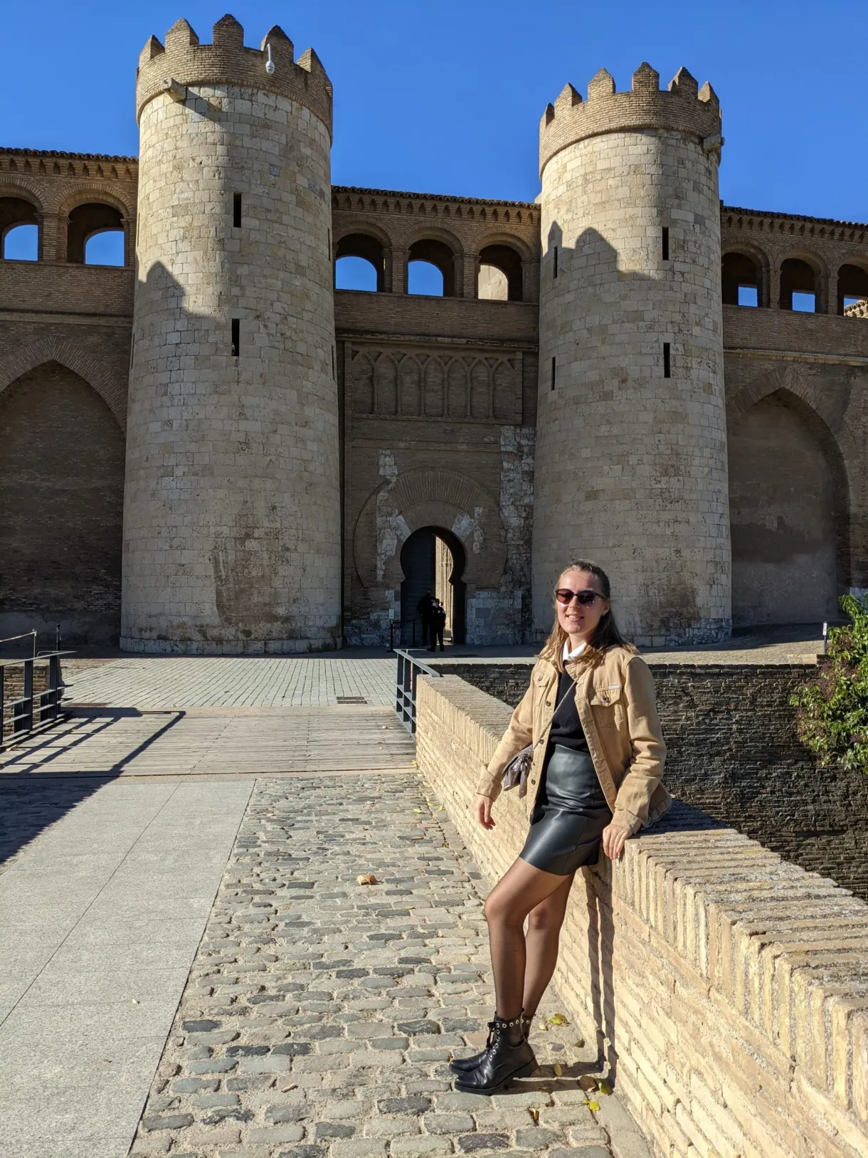 Woman on the walkway leading to the palace gate