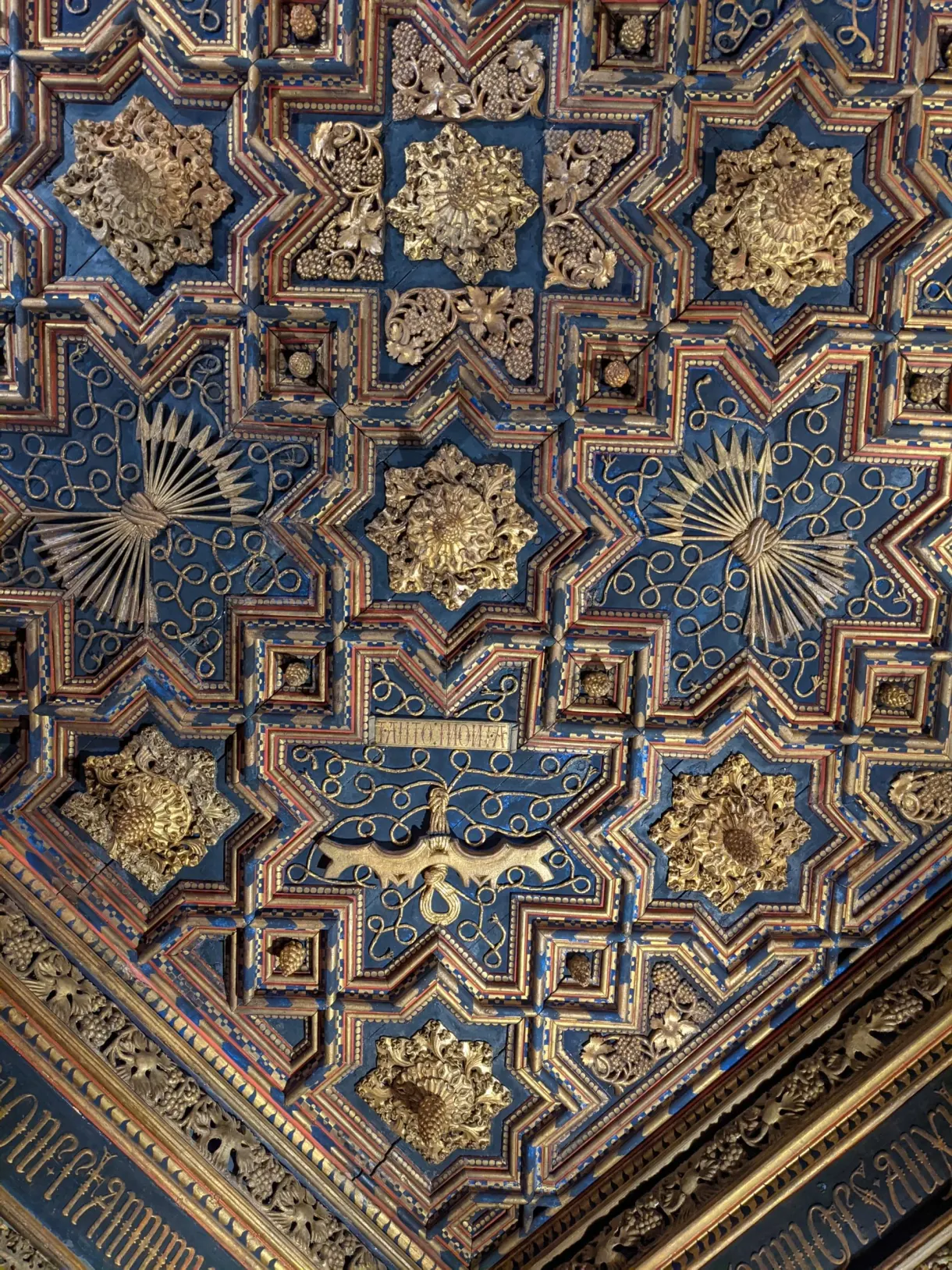 Blue and gold dome with star patterns in close-up