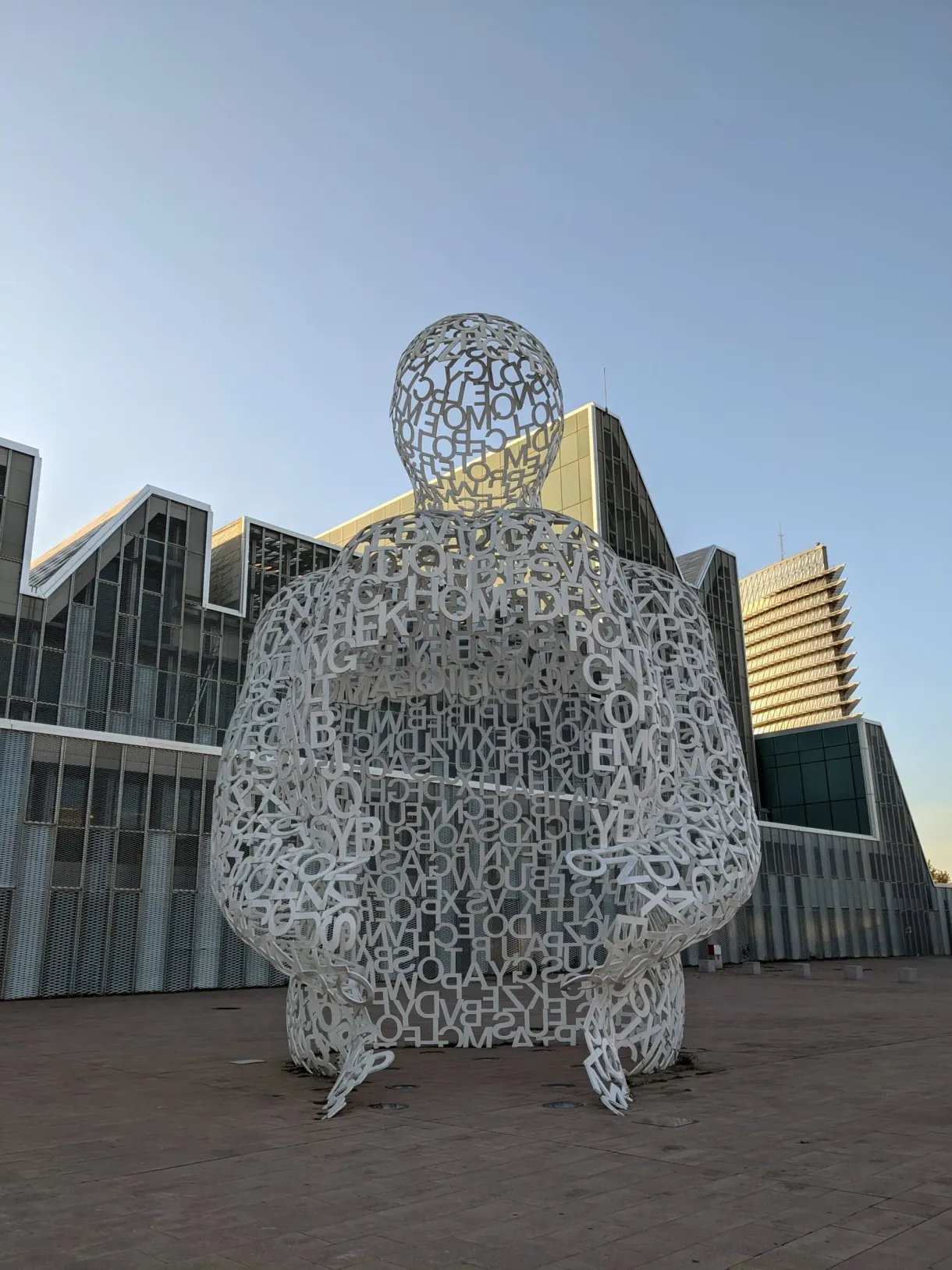 Openwork silhouette standing in front of the Expo pavilions