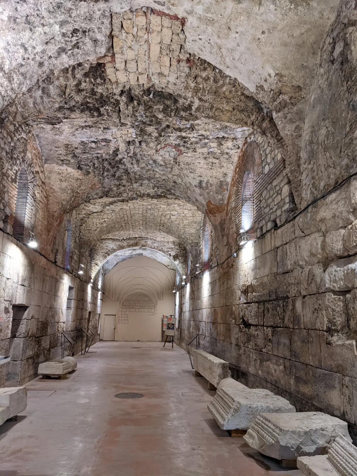 Vast vaulted underground hall with bare stone walls