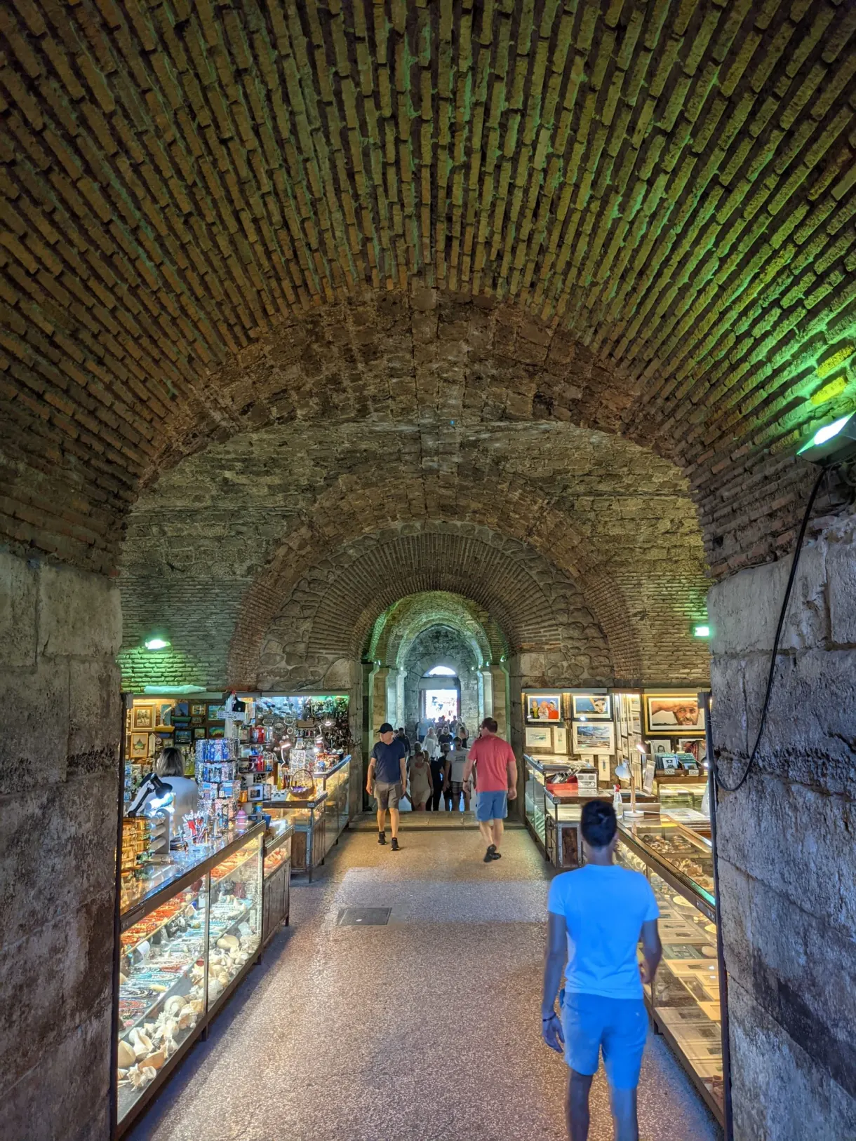 Vaulted gallery filled with souvenir stalls