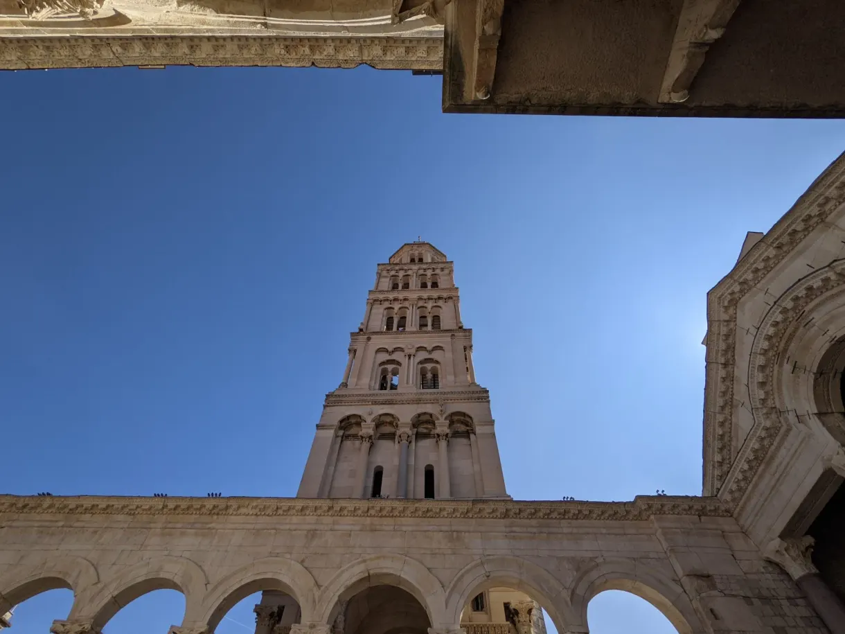 Cathedral bell tower seen from below against a blue sky