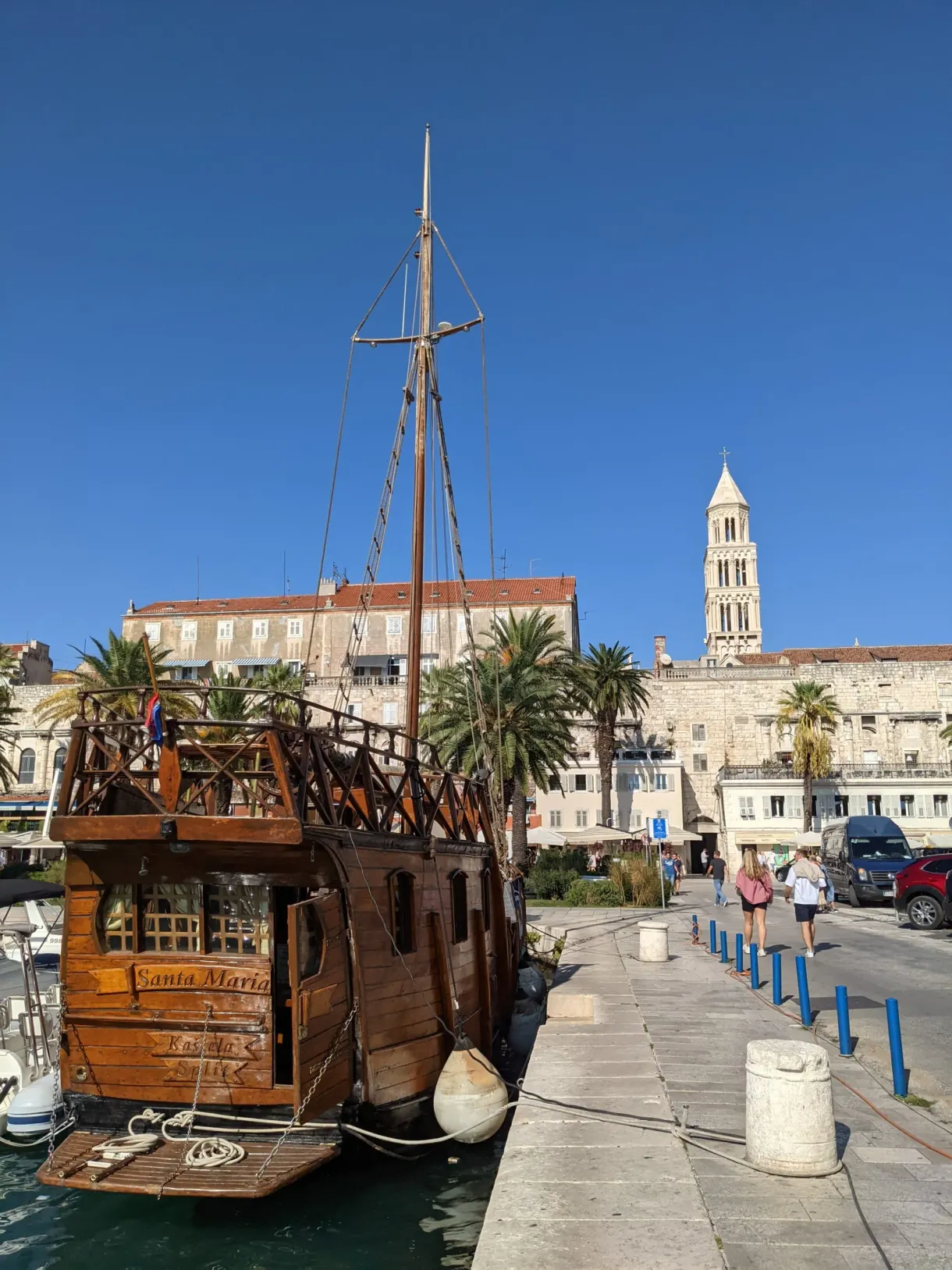 Wooden galleon moored at the quay in front of the bell tower