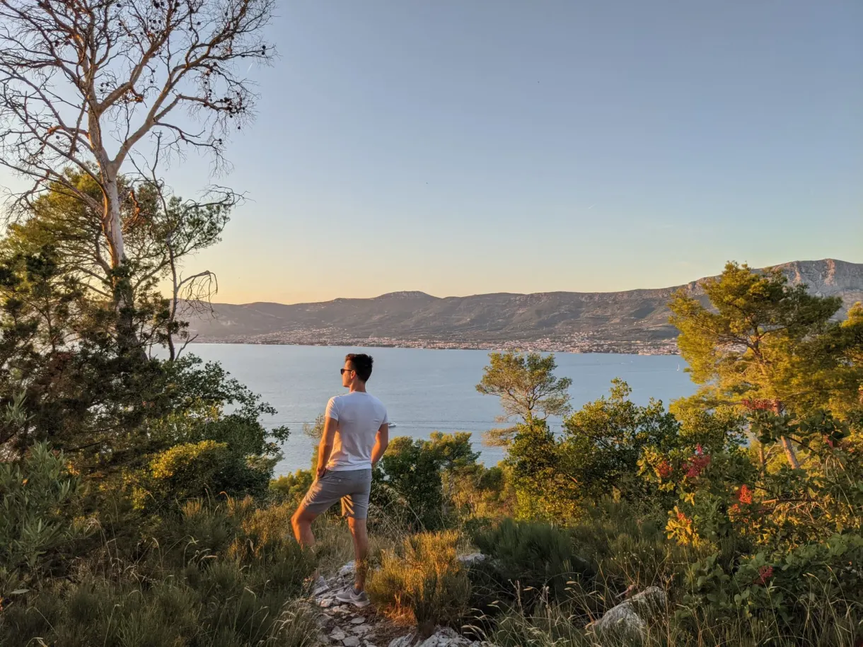 Man standing on a promontory in the golden light