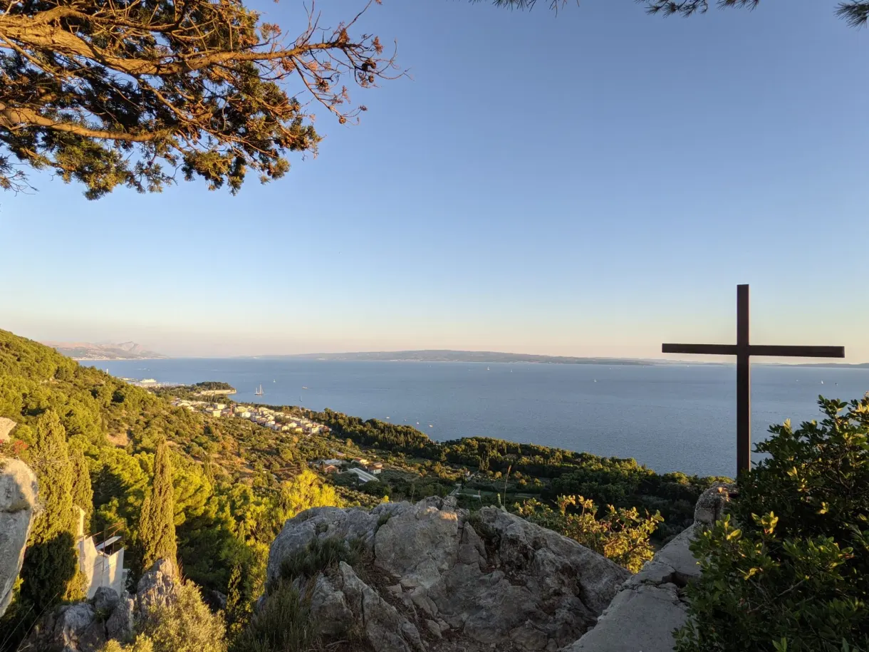 Wooden cross set on a rock above the sea