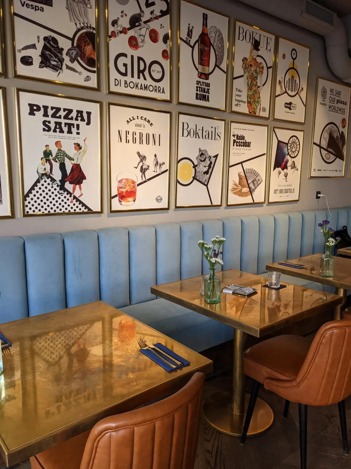 Blue bench seat and colourful posters in a pizzeria