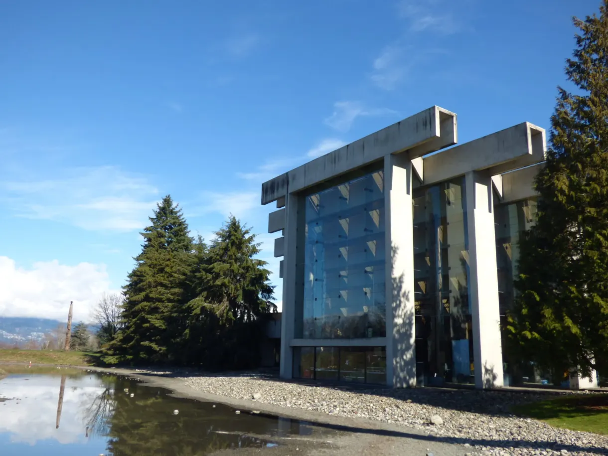 Concrete and glass building reflected in a pool