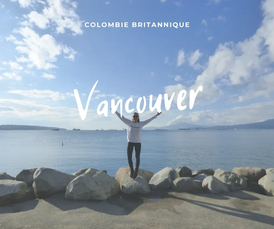Arms raised on a rock facing the bay, Vancouver title