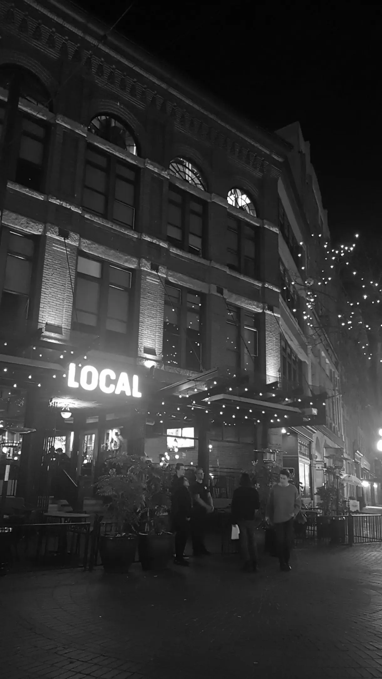 Black and white bar façade at nightfall
