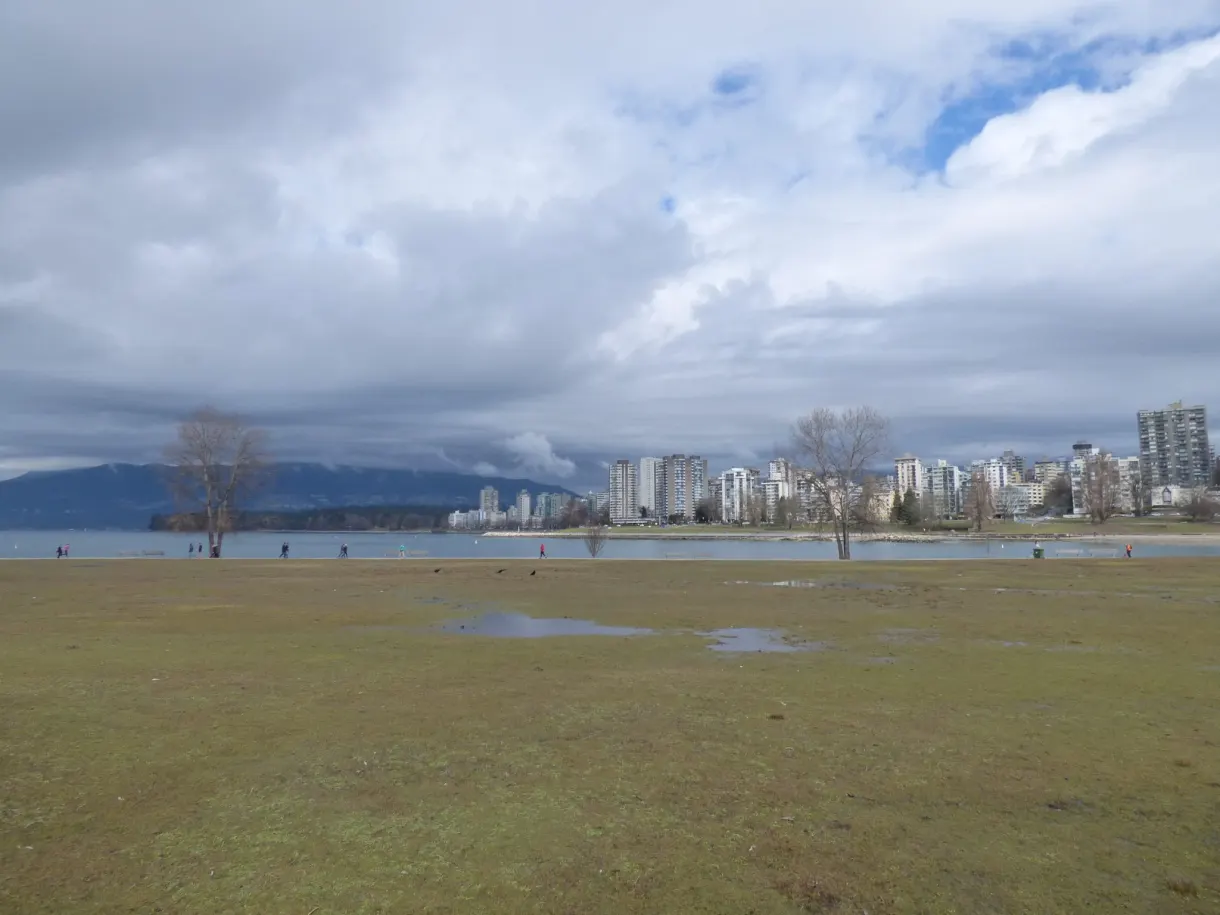 Vast waterlogged lawn opening onto the city in the distance