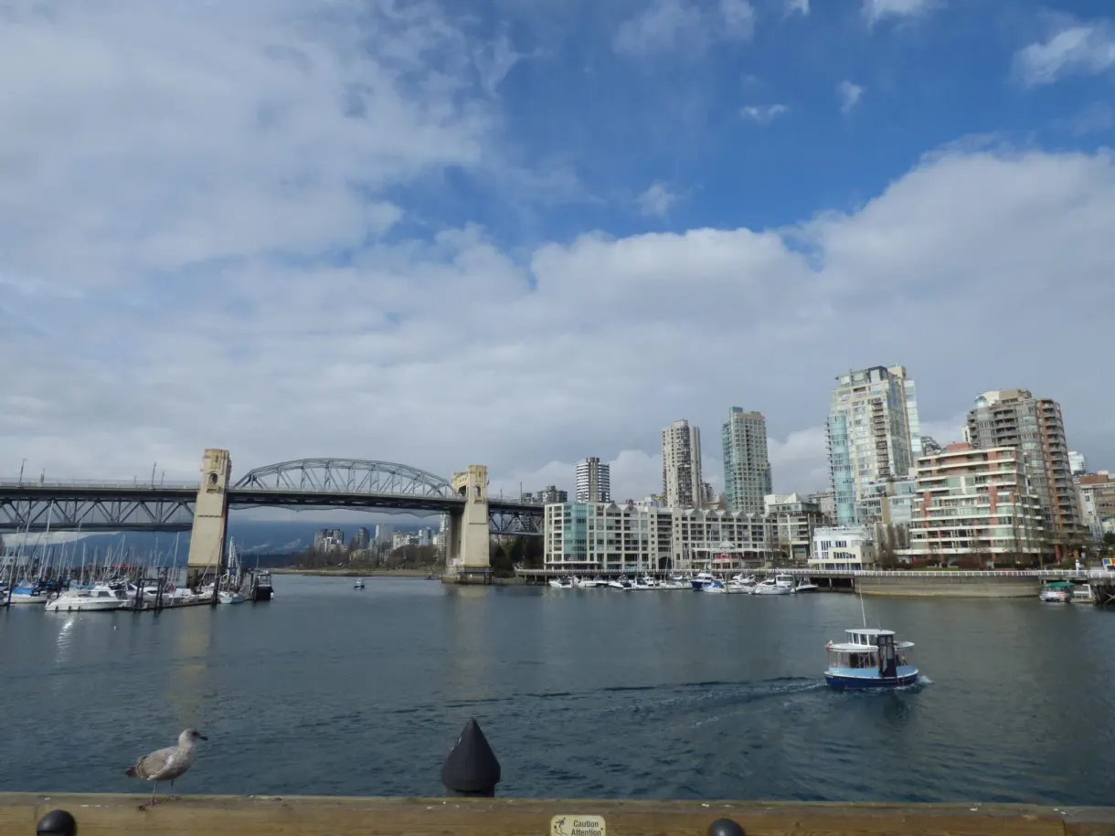 Water taxi crossing in front of the bridge and the towers