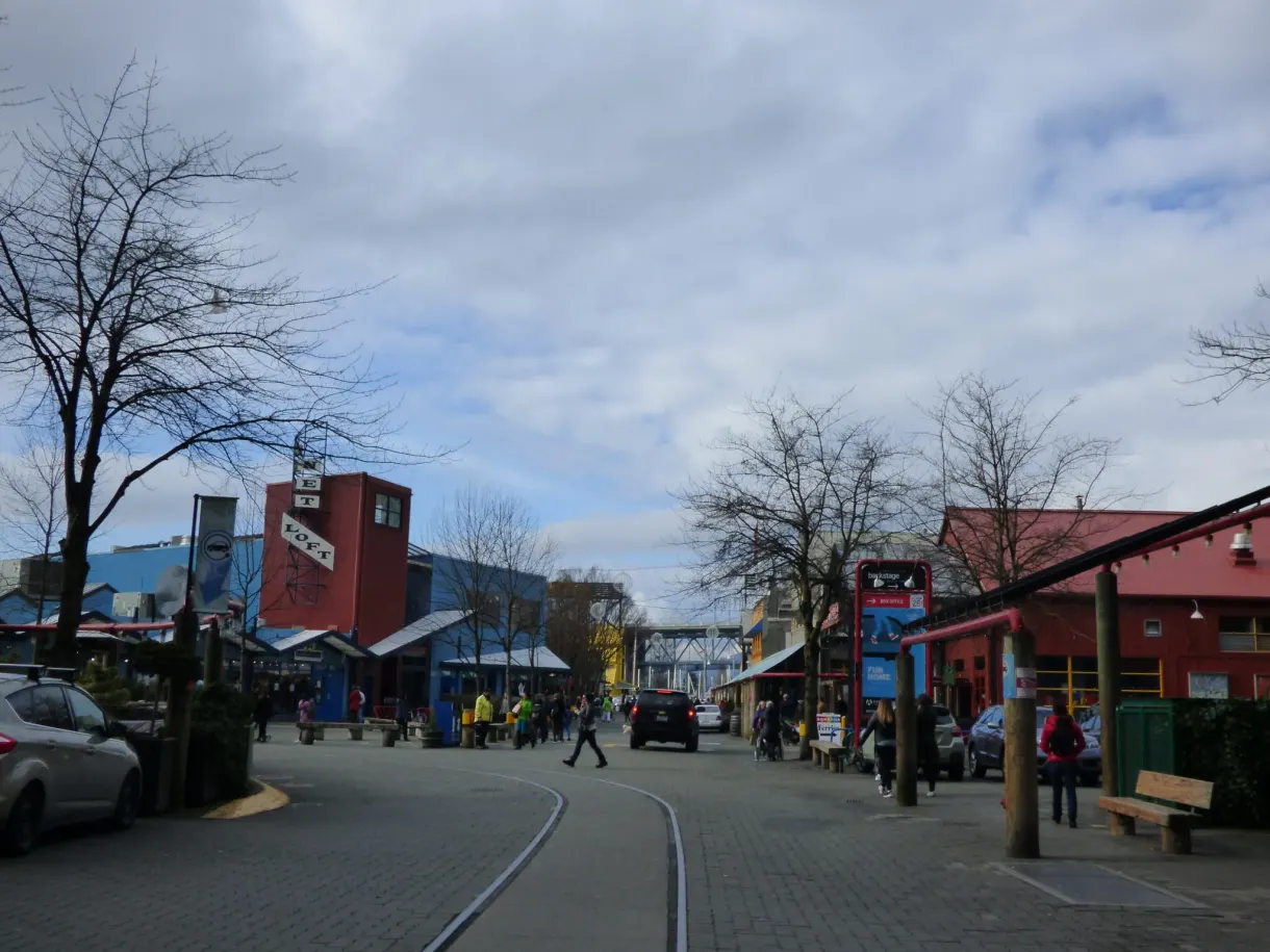 Street on Granville Island, embedded rails and red warehouses