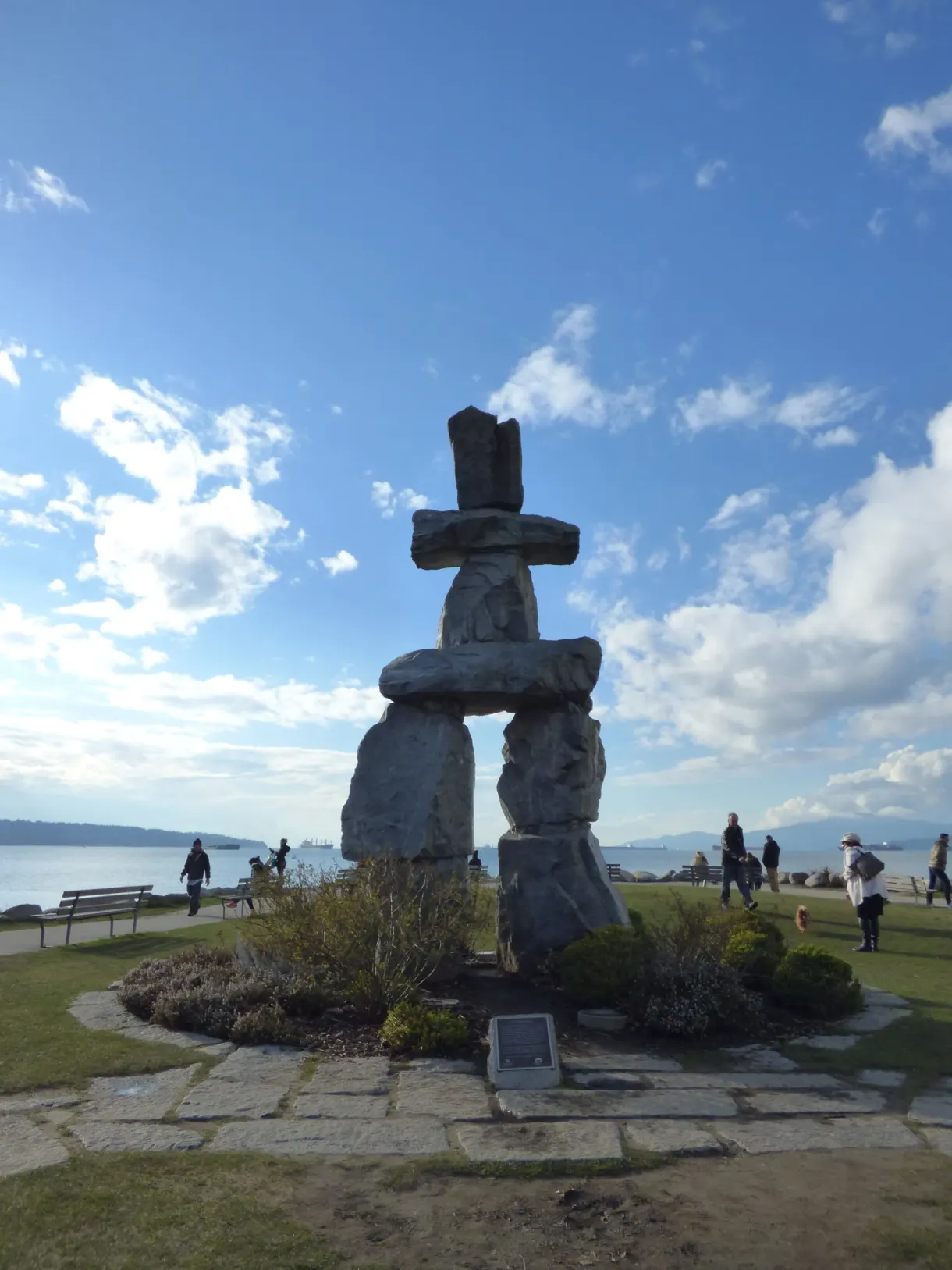 Inukshuk of stacked stones against the blue sky