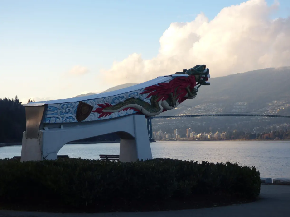 Carved and painted canoe prow facing the water