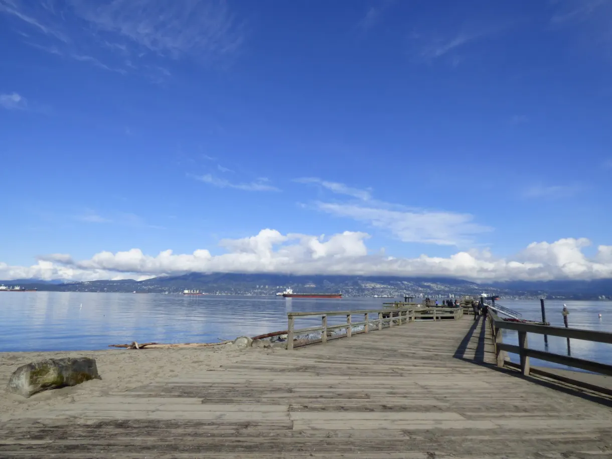 Wooden jetty reaching out towards the calm water