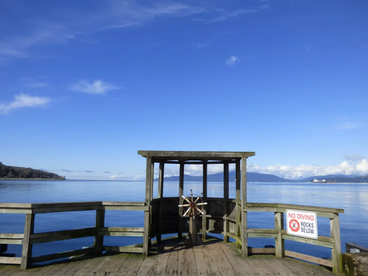 Wooden shelter at the end of the jetty and a prohibition sign