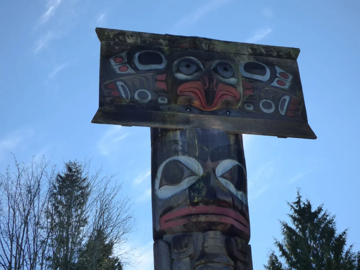Carved and painted beam resting on a wooden post