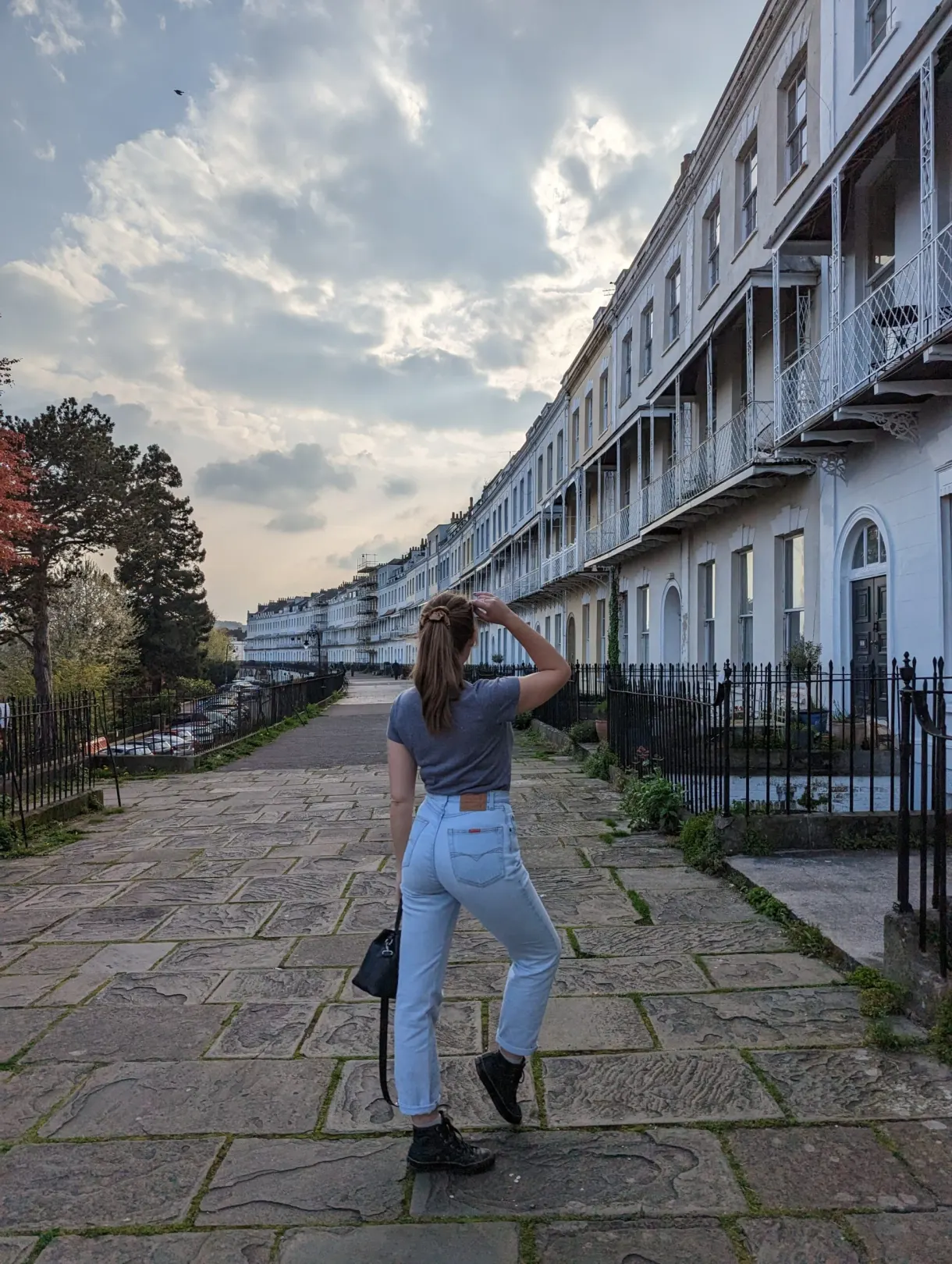 In front of a Georgian crescent, walking on the stone flags