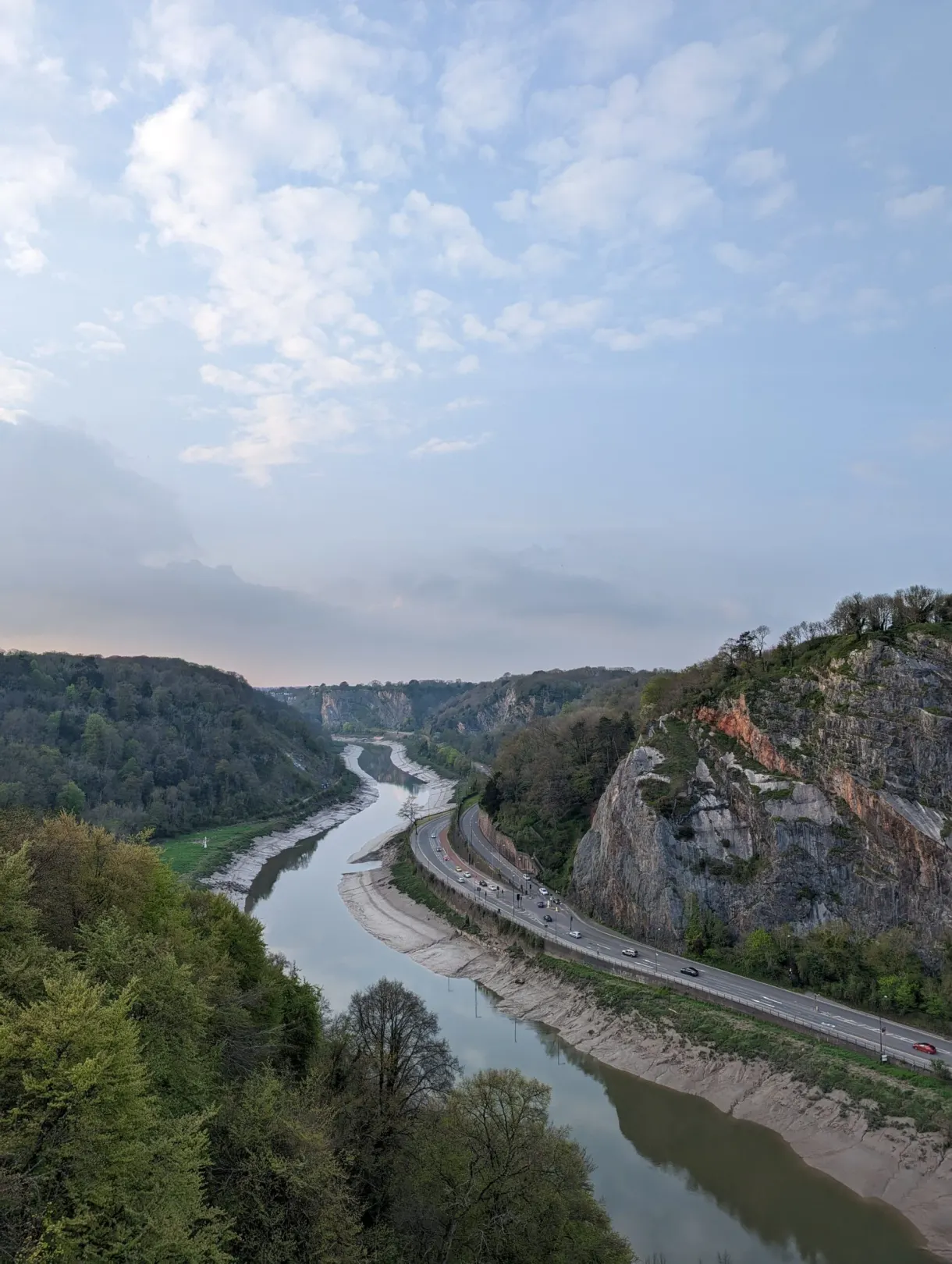 Wooded gorge carved by the river down below