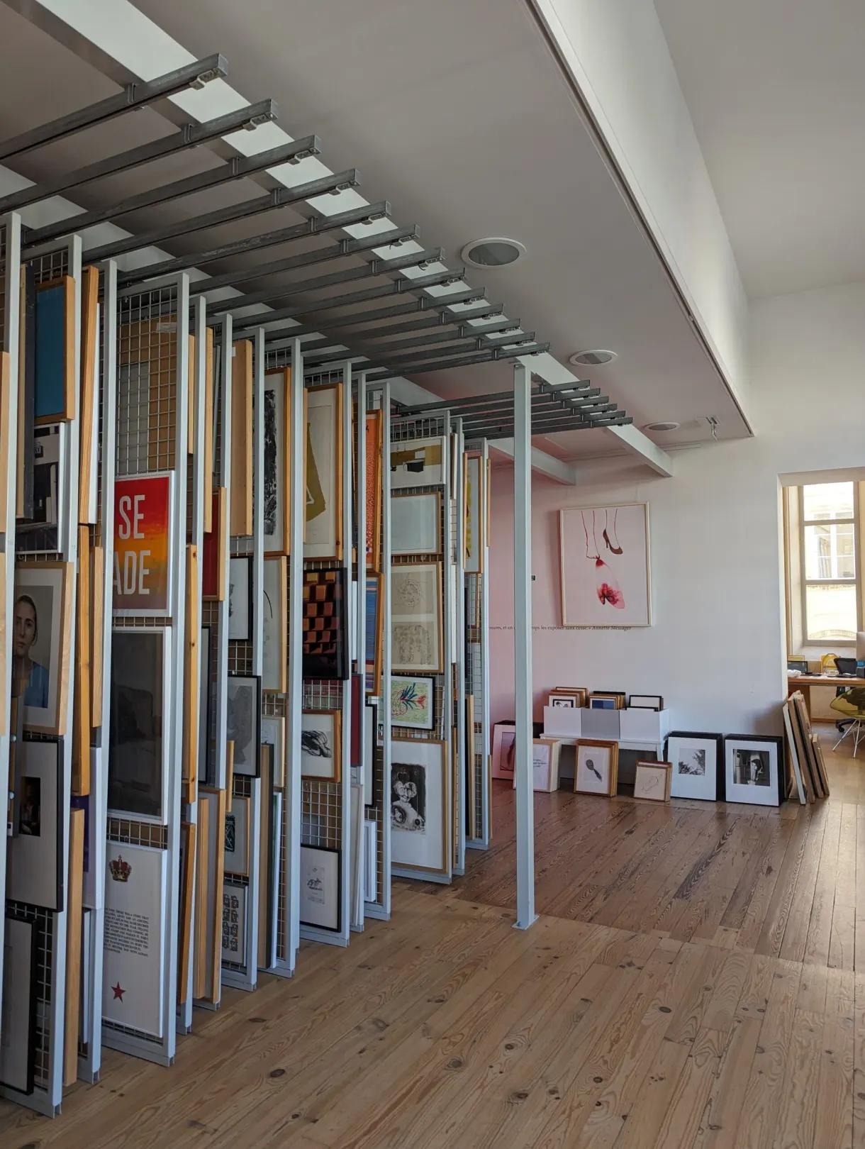 Movable display panels covered with posters in a gallery with a pale wooden floor