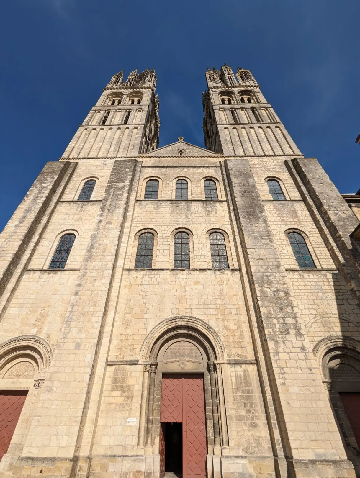 Low angle view of the two Romanesque towers of the Saint-Étienne abbey church