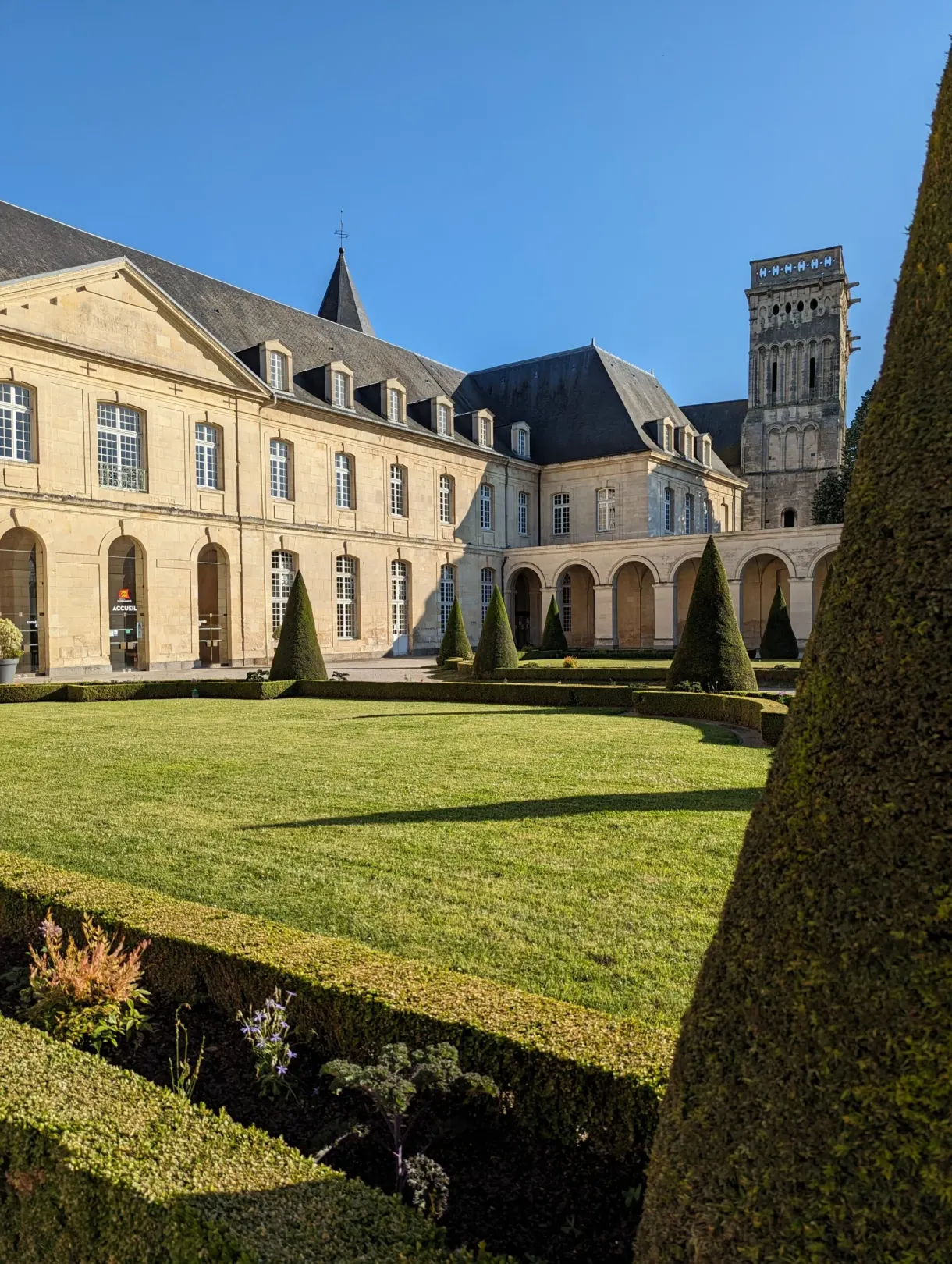 Lawn and clipped hedges of the garden in front of the abbey