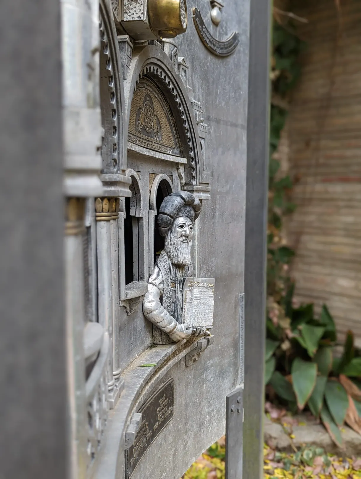 Detail of a carved doorway, bearded figure holding a book