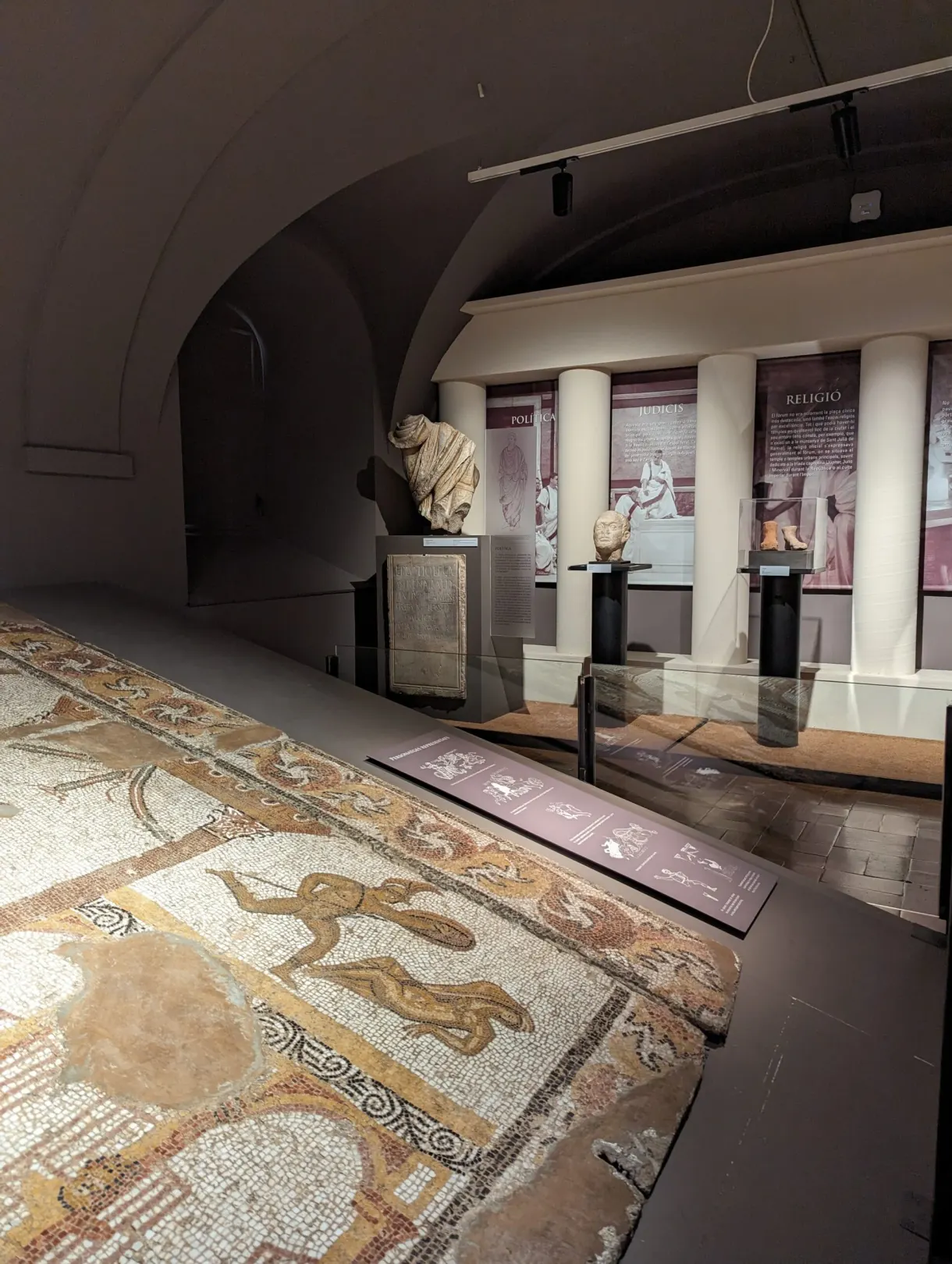 Large Roman mosaic on the floor and ancient busts in a display case