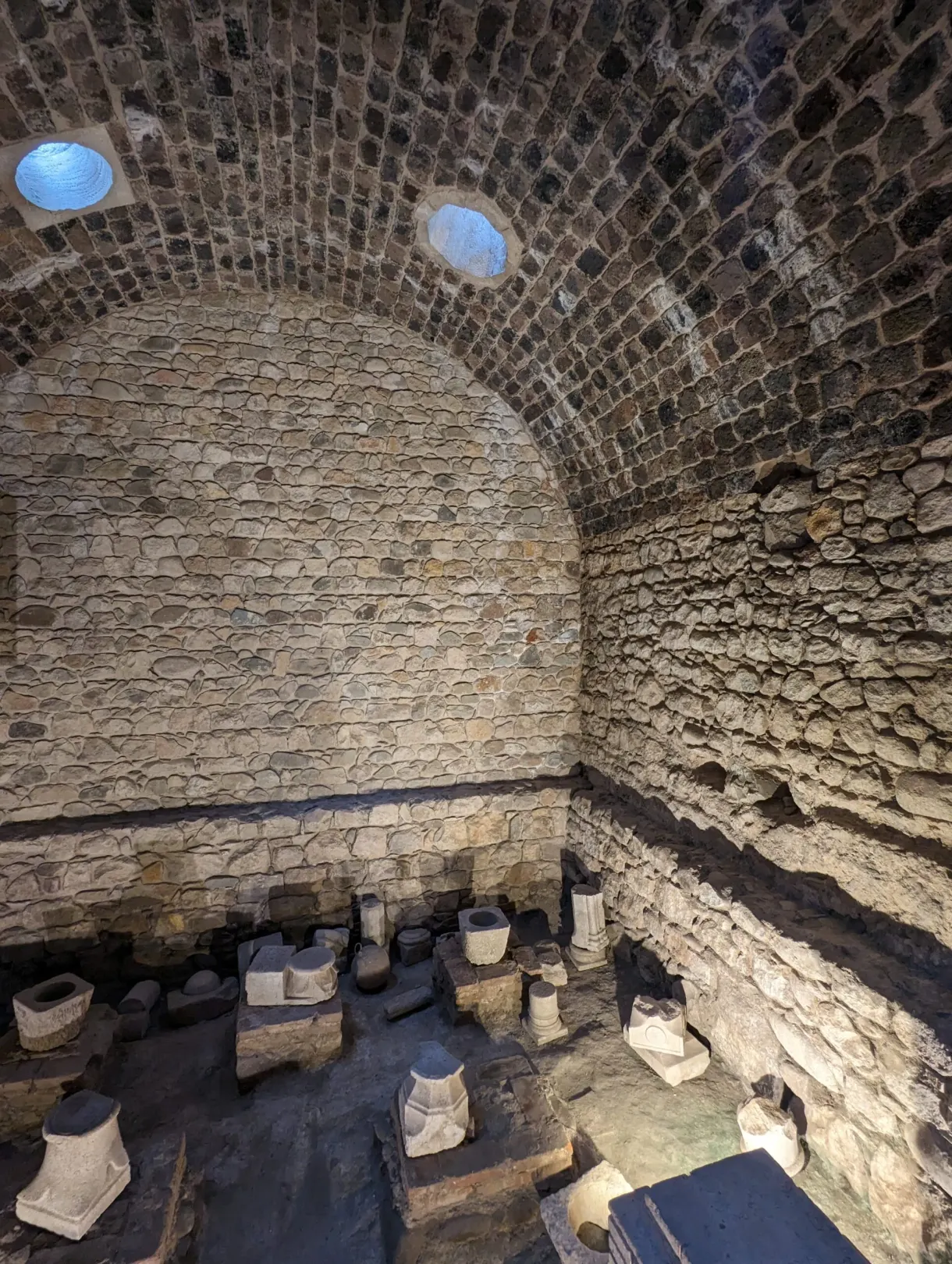 Underground room with hypocaust pillars and glazed oculi in the ceiling